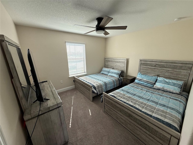 bedroom featuring baseboards, carpet floors, a textured ceiling, and a ceiling fan