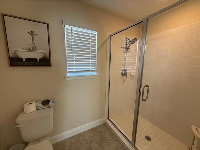 full bath featuring a shower stall, toilet, and baseboards