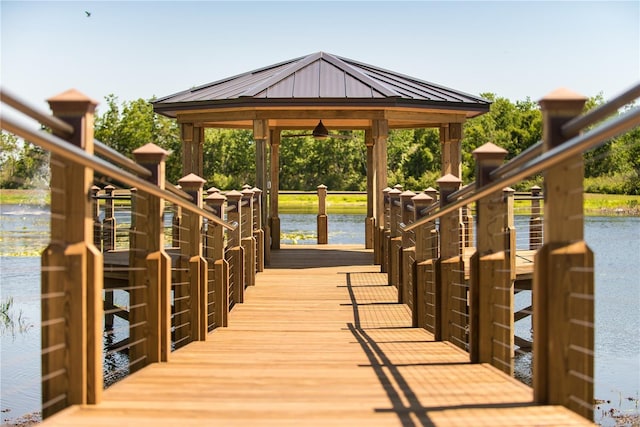 view of dock featuring a gazebo and a water view