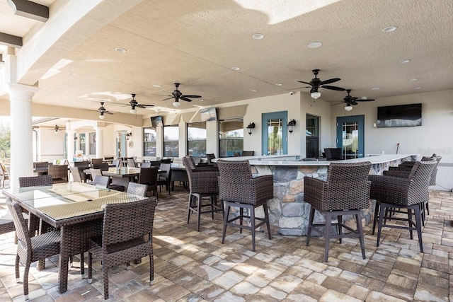 199 Macaulays Cv, Haines City, FL 33844 - view of patio / terrace with outdoor dining space, exterior bar, and ceiling fan