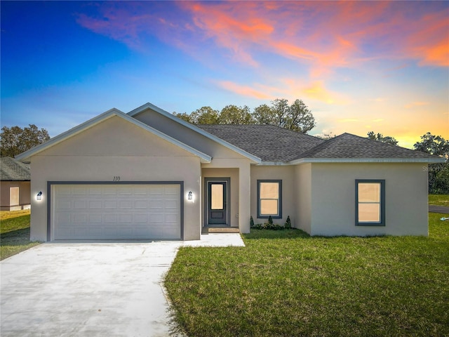 ranch-style home featuring roof with shingles, stucco siding, concrete driveway, a front yard, and a garage