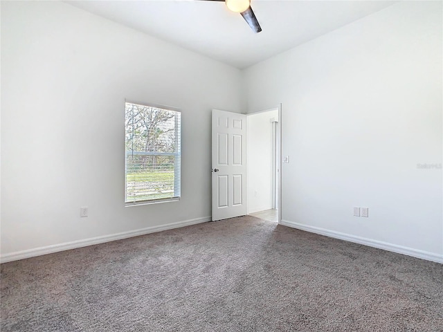 carpeted empty room with baseboards