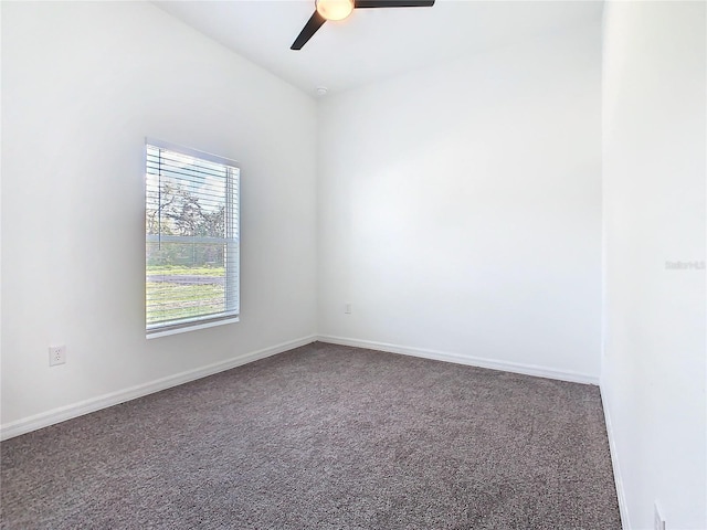 carpeted empty room featuring ceiling fan and baseboards