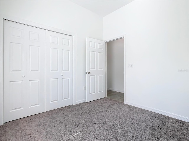 unfurnished bedroom featuring a closet, carpet flooring, and baseboards