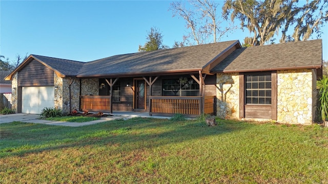 ranch-style home featuring an attached garage, stone siding, covered porch, and a front yard