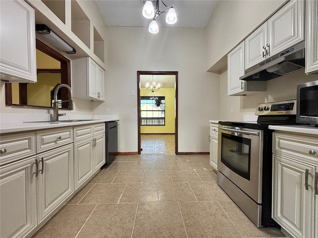 kitchen with appliances with stainless steel finishes, an inviting chandelier, a sink, and under cabinet range hood