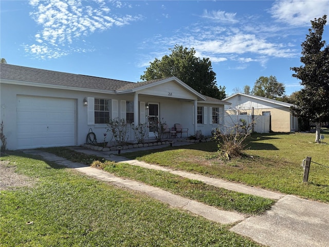 single story home with a porch, an attached garage, fence, stucco siding, and a front lawn