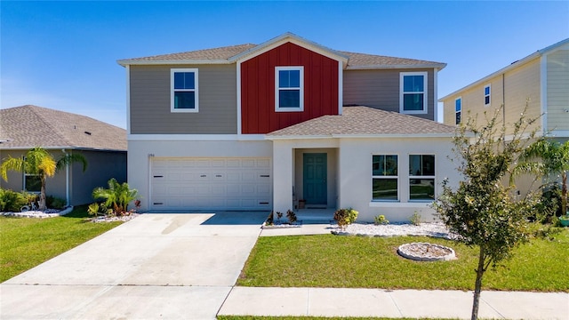 view of front of property with driveway, an attached garage, board and batten siding, and a front yard