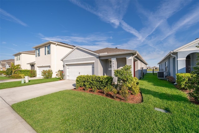 view of front of house with a garage, concrete driveway, a residential view, a front lawn, and stucco siding