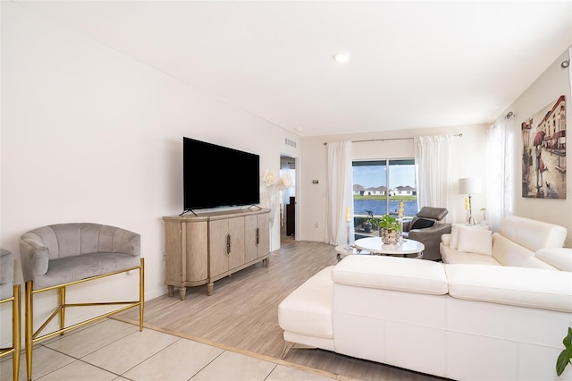 living area with light wood finished floors and visible vents