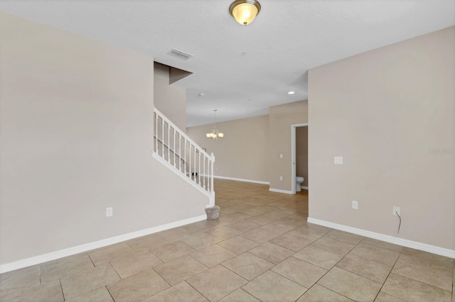 empty room with baseboards, stairway, visible vents, and a notable chandelier