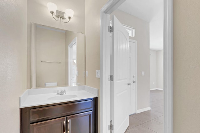 bathroom featuring tile patterned flooring, vanity, and baseboards