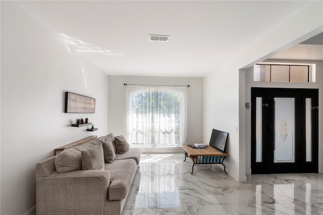 living area with marble finish floor and visible vents