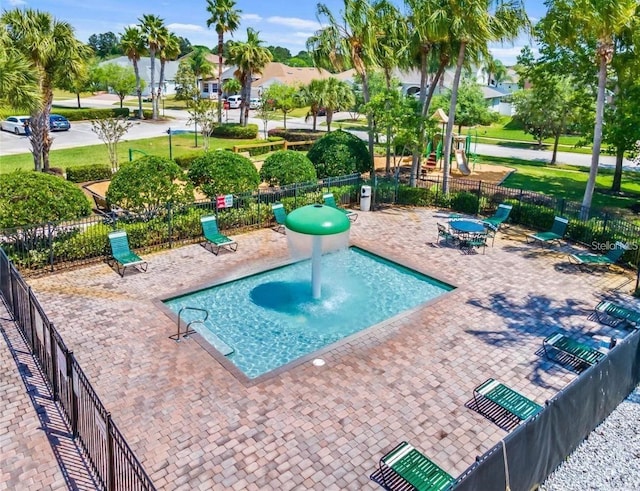 view of swimming pool featuring fence, playground community, and a patio