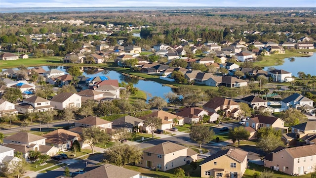 drone / aerial view with a water view and a residential view