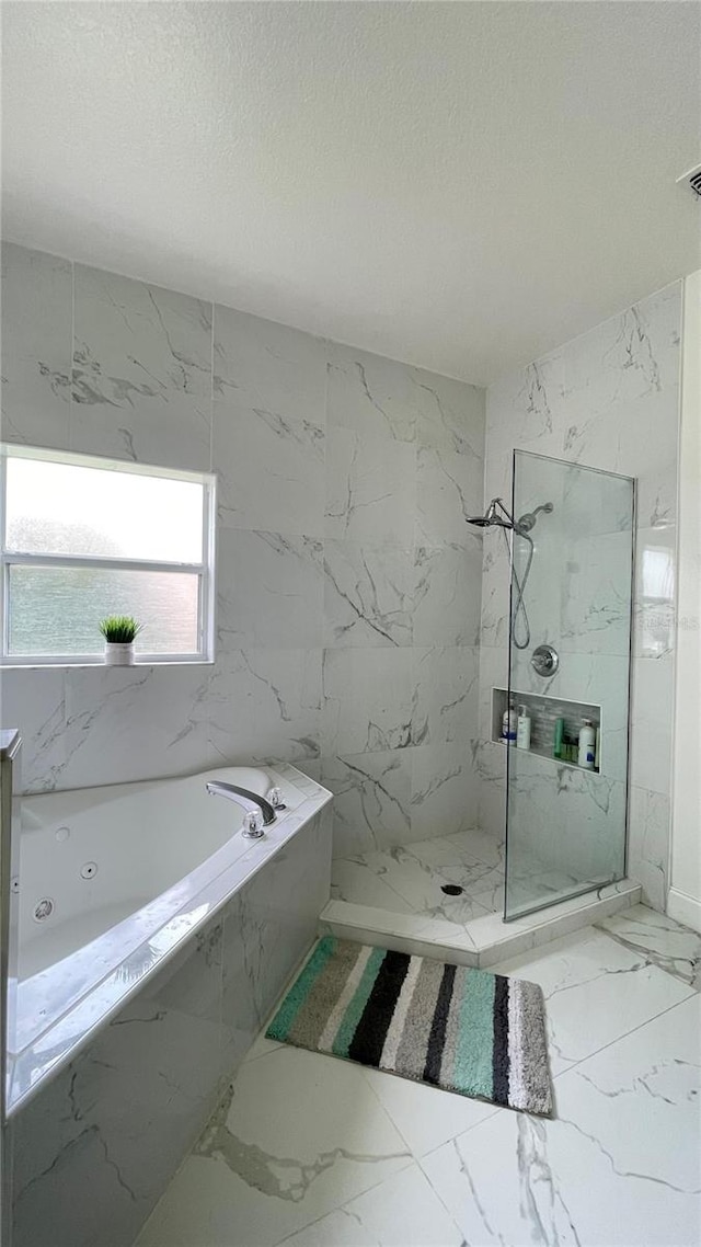 4301 Presidio Way, Kissimmee, FL 34746 - full bathroom featuring marble look tile flooring, a garden tub, a marble finish shower, and a textured ceiling