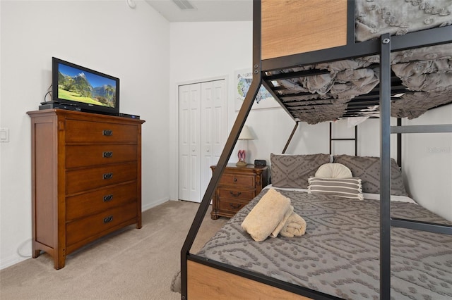 bedroom with light carpet and a closet