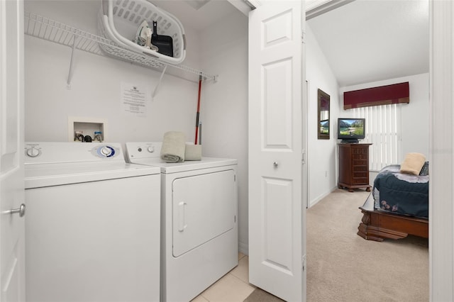 clothes washing area with light carpet, laundry area, and washer and clothes dryer