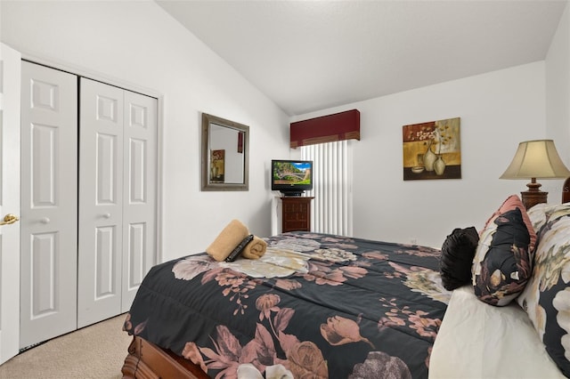 carpeted bedroom featuring lofted ceiling and a closet