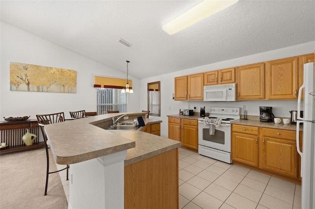 kitchen with a breakfast bar, a center island with sink, vaulted ceiling, a sink, and white appliances