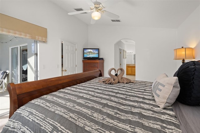 bedroom featuring arched walkways, vaulted ceiling, visible vents, and ensuite bathroom