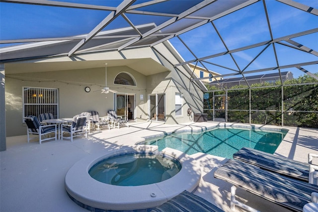 view of swimming pool featuring a pool with connected hot tub, a patio area, ceiling fan, and a lanai