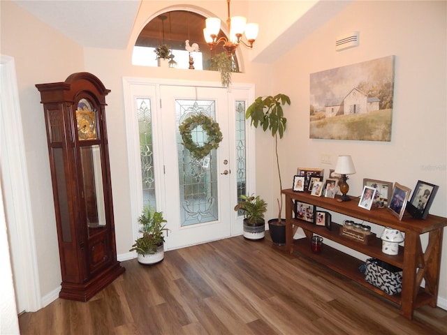 foyer entrance with a chandelier and wood finished floors