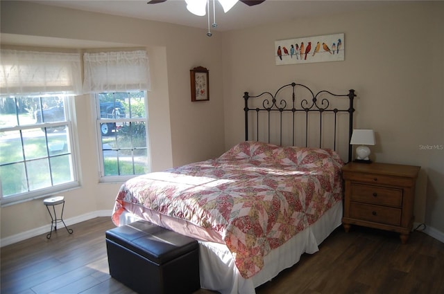 bedroom featuring a ceiling fan, baseboards, and dark wood-style flooring