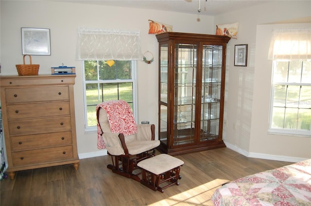 bedroom with access to outside, dark wood-style flooring, and baseboards