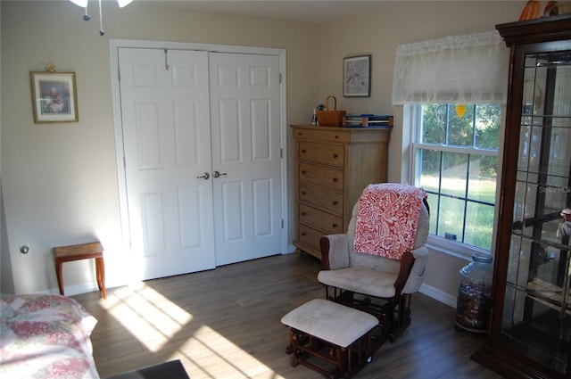 sitting room featuring baseboards and wood finished floors