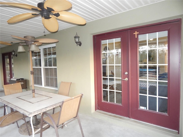 sunroom / solarium featuring a ceiling fan and french doors