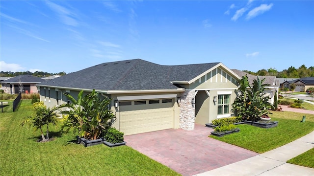 view of front of home featuring an attached garage, roof with shingles, decorative driveway, stucco siding, and a front lawn