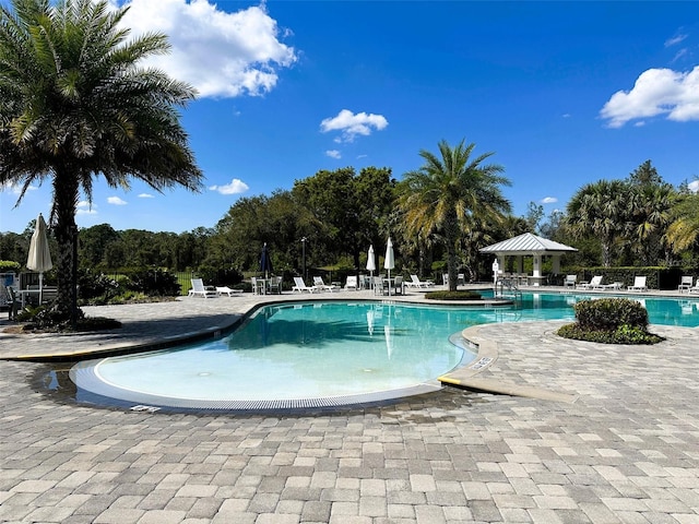 pool featuring a gazebo and a patio