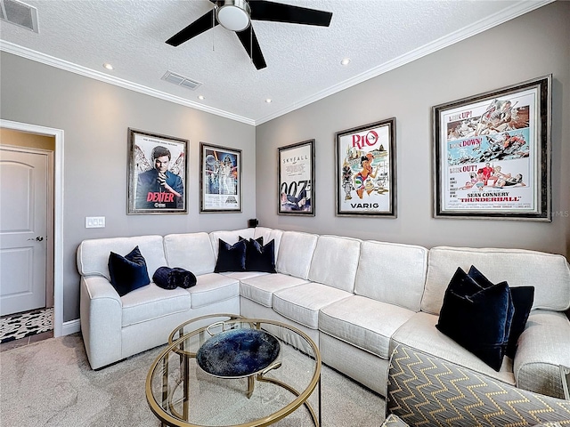 carpeted living room with ornamental molding, visible vents, a textured ceiling, and a ceiling fan