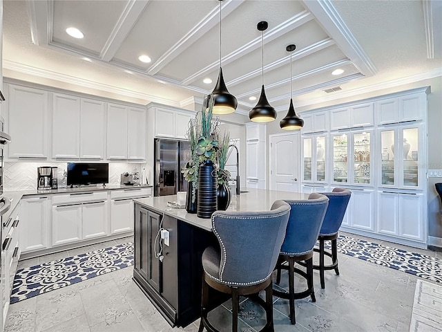 kitchen with tasteful backsplash, stainless steel refrigerator with ice dispenser, visible vents, and crown molding