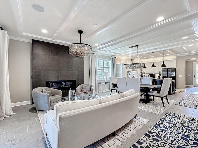 living area featuring crown molding, a fireplace, baseboards, and beam ceiling