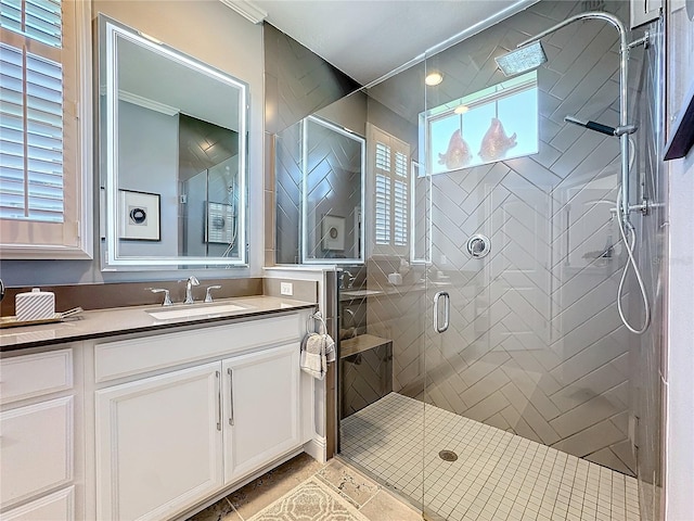 full bathroom featuring tile patterned flooring, a shower stall, and vanity