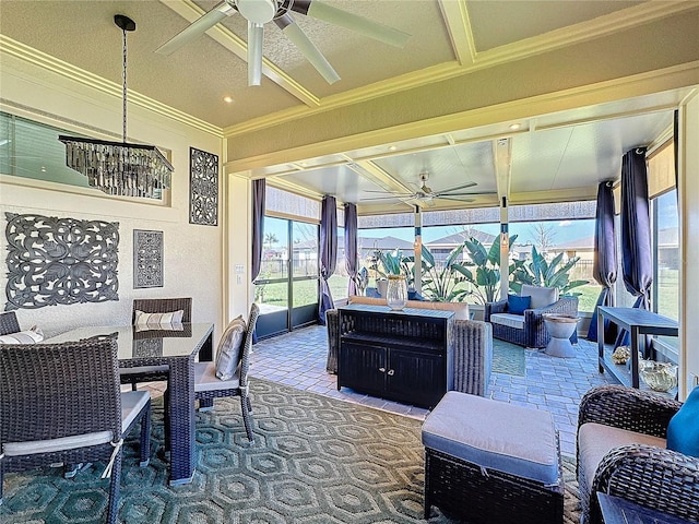 sunroom featuring a ceiling fan