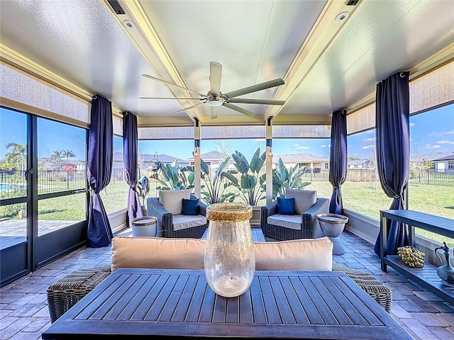 sunroom / solarium featuring a ceiling fan