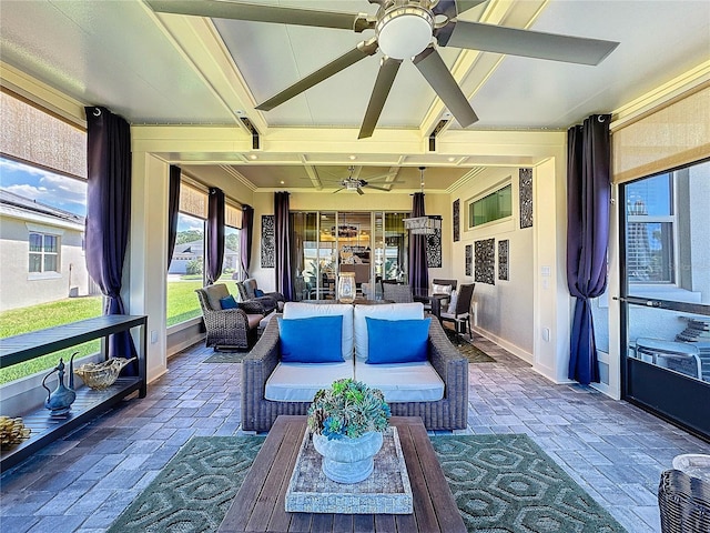 sunroom with a ceiling fan and beamed ceiling