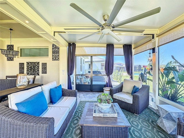 sunroom featuring a ceiling fan