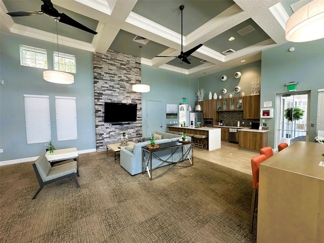 living room featuring ceiling fan, a high ceiling, visible vents, and coffered ceiling