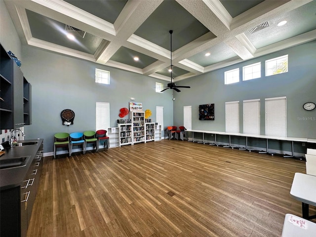 miscellaneous room with a towering ceiling, dark wood-style floors, visible vents, and coffered ceiling