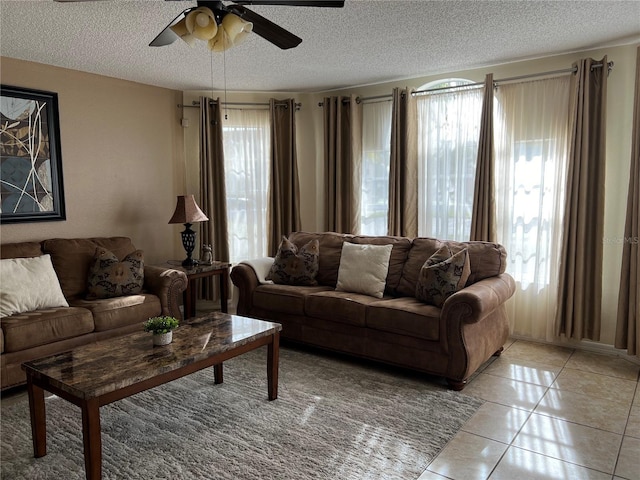 2494 Sweetwater Club Cir Unit 55, Kissimmee, FL 34746 - living area featuring a textured ceiling, light tile patterned flooring, and a ceiling fan