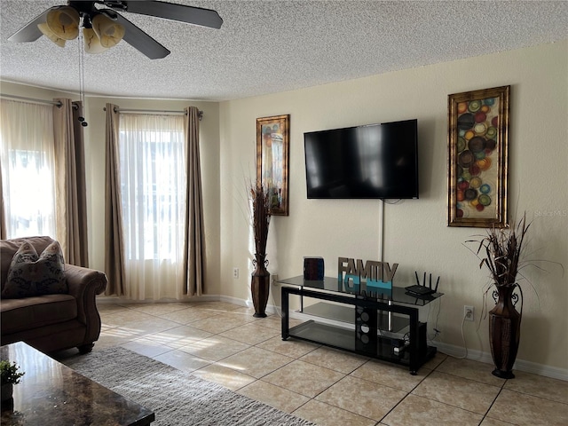 2494 Sweetwater Club Cir Unit 55, Kissimmee, FL 34746 - living area with a textured ceiling, light tile patterned flooring, a ceiling fan, and baseboards