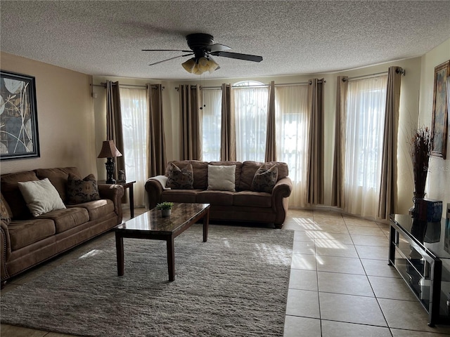 2494 Sweetwater Club Cir Unit 55, Kissimmee, FL 34746 - living room with a ceiling fan, a textured ceiling, and light tile patterned flooring