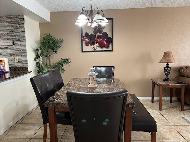 2494 Sweetwater Club Cir Unit 55, Kissimmee, FL 34746 - dining space featuring a chandelier, a textured ceiling, light tile patterned flooring, and baseboards