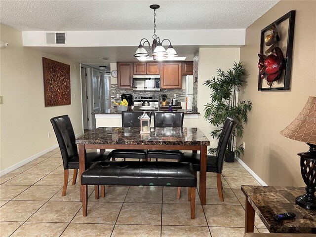 2494 Sweetwater Club Cir Unit 55, Kissimmee, FL 34746 - dining space with light tile patterned floors, a textured ceiling, and visible vents