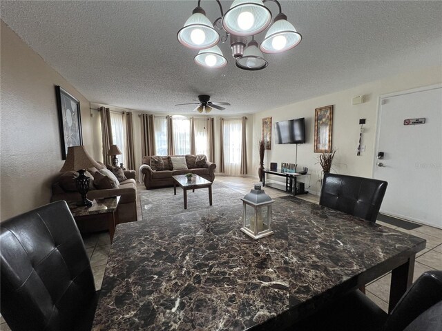 2494 Sweetwater Club Cir Unit 55, Kissimmee, FL 34746 - living room featuring ceiling fan with notable chandelier, a textured ceiling, and light tile patterned floors