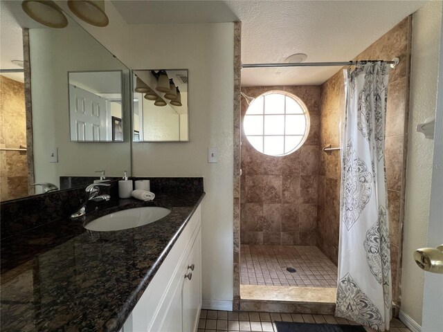 2494 Sweetwater Club Cir Unit 55, Kissimmee, FL 34746 - bathroom with a stall shower, tile patterned flooring, a textured ceiling, and vanity